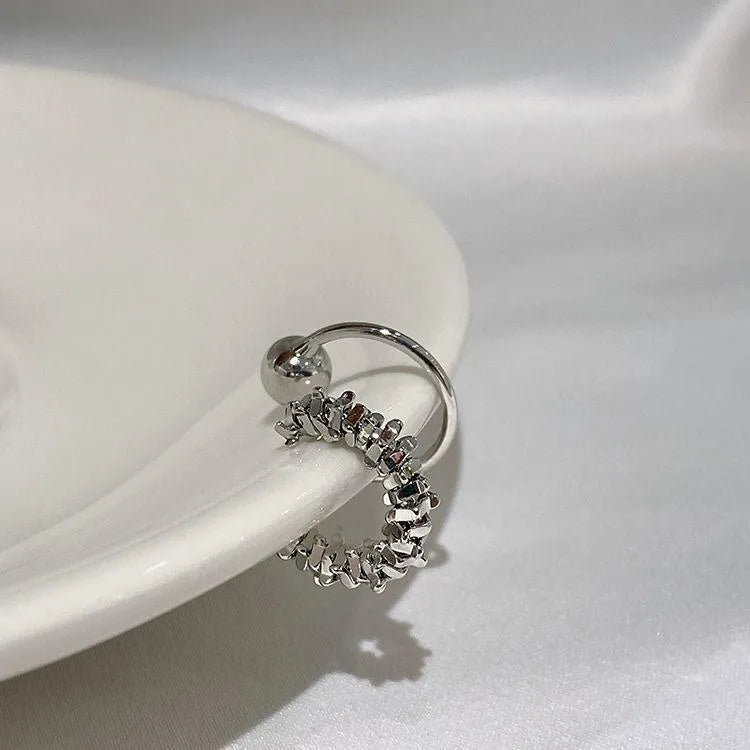 Pair of silver-toned geometric clip-on earrings with a frosty textured finish.