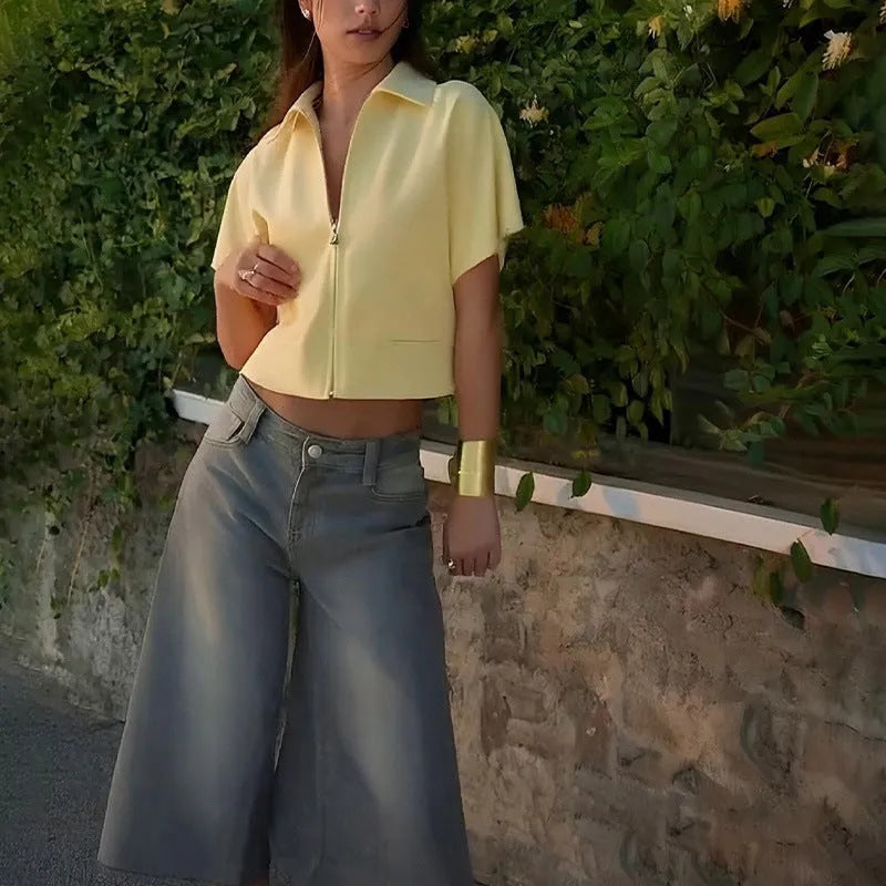 Loose fit casual polyester top in yellow on a hanger