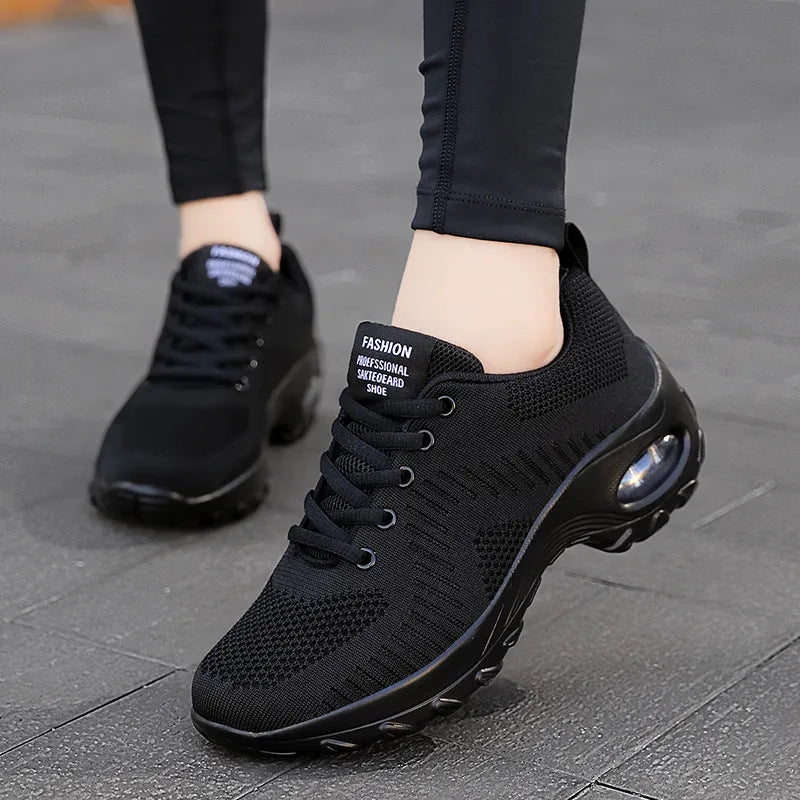 Red and black women's low top lace-up mesh sneakers with a round toe and flat PU sole.