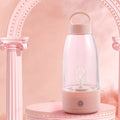Automatic electric shaker bottle in green with USB charging port and handle.
