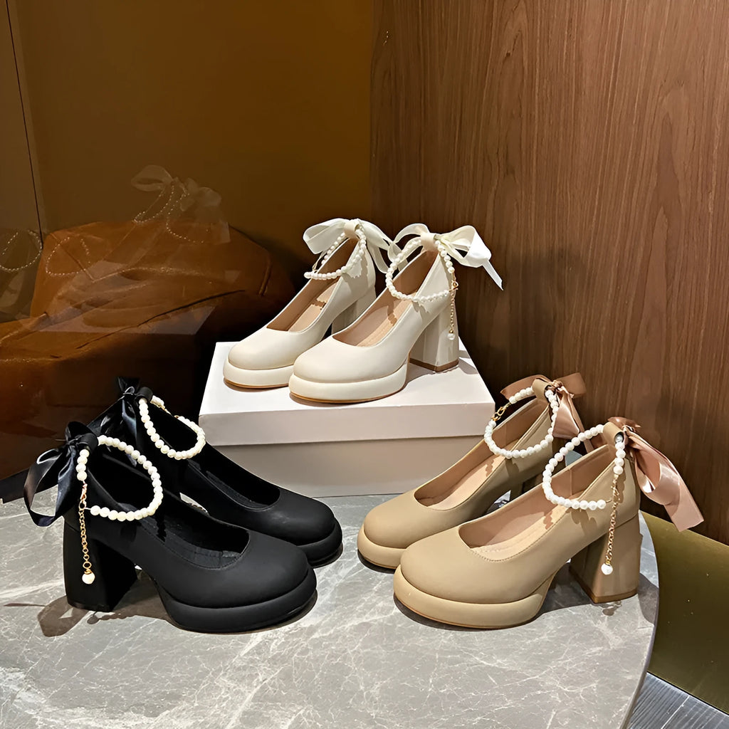 Women's beige Mary Jane shoes with a chunky block heel and an ankle-strap buckle on a round toe.