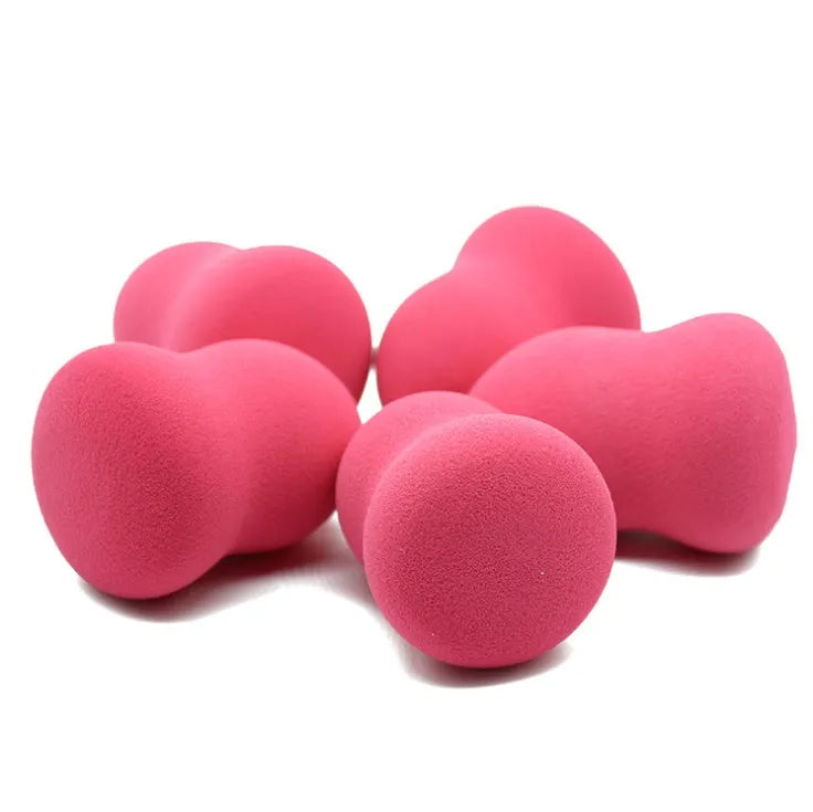 Pink hydrophilic non-latex makeup sponge puff on a white background