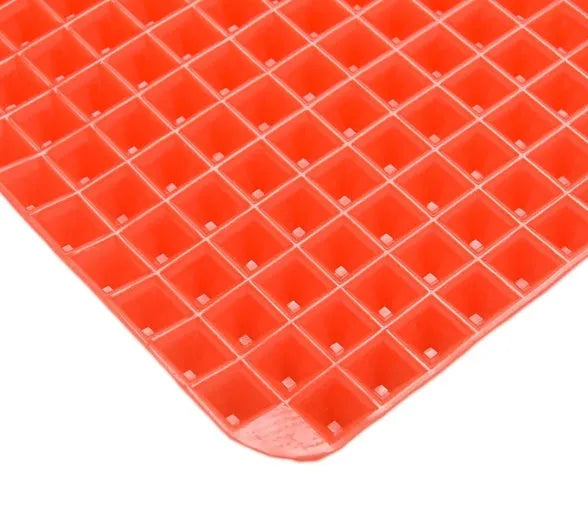 Red silicone pyramid grid cooking mat for oven and BBQ use
