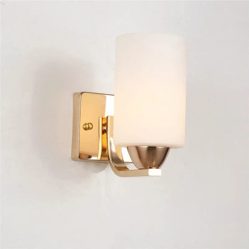 Modern chrome and glass wall lamp with single head design showing glass lampshade and metallic finish