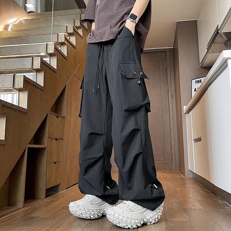 Plus size black waterproof loose straight-leg trousers with drawstring waist on hanger