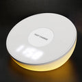 White wireless phone charger with digital clock display and three control buttons on the front.