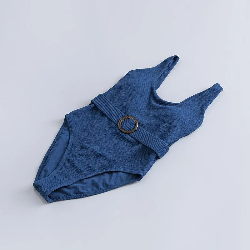 Navy blue women's one-piece swimsuit with slimming triangle design and built-in chest pad
