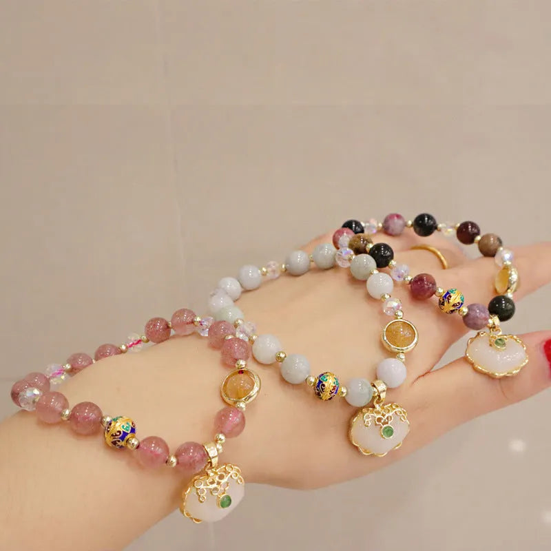 Geometric ethnic bracelet for women in choice of gray jade or strawberry quartz stone with metal decoration.