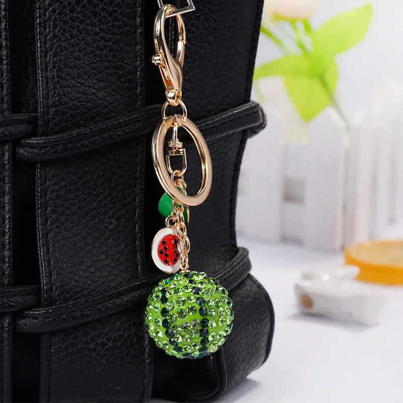 Green watermelon-shaped zinc alloy keychain measuring 12cm with fruit diamond design