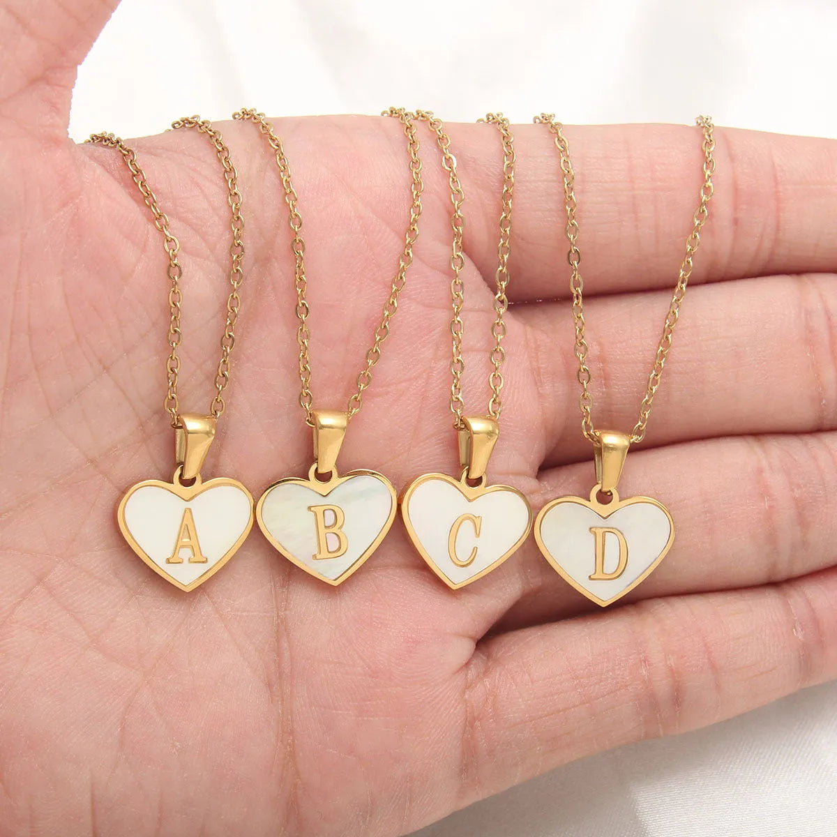 Gold-plated heart necklace with white shell design on adjustable stainless steel chain