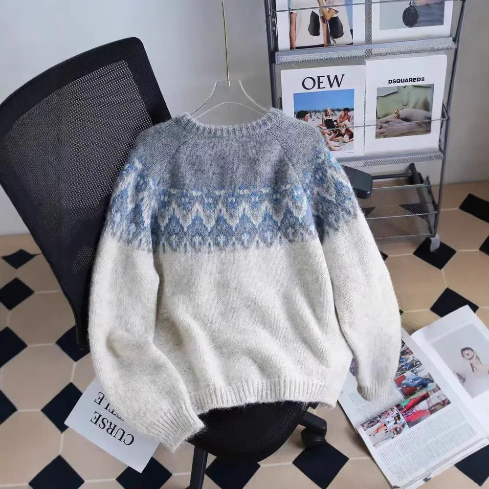 Women's beige jacquard knit sweater coat with contrast pattern, shown on a hanger.