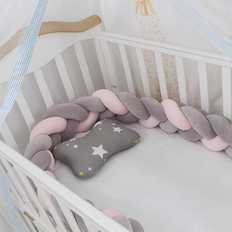 Multi-colour baby crib bumper made of spandex velvet, shown bent around a crib edge.