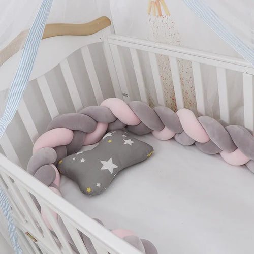 Multi-colour baby crib bumper made of spandex velvet, shown bent around a crib edge.