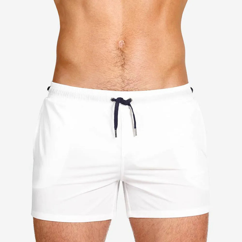 Solid colour polyester swimming and sports shorts with mesh lining in army green, on a white background.