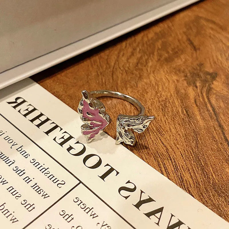 Copper butterfly women's ring with oil-drip finish showing open-loop design