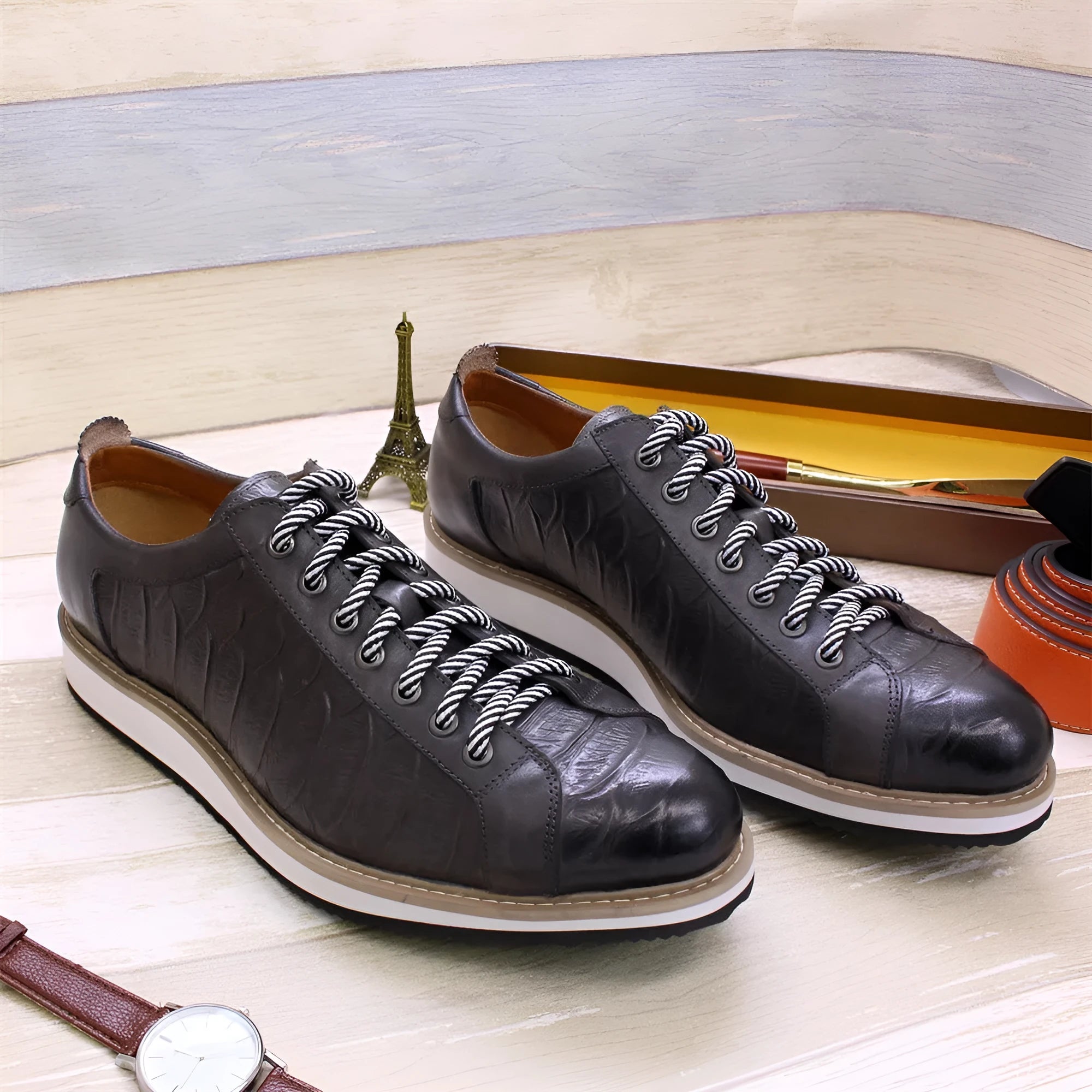 Low-top handmade men's shoes with an embossed pattern, shown in a choice of colours including black and green.