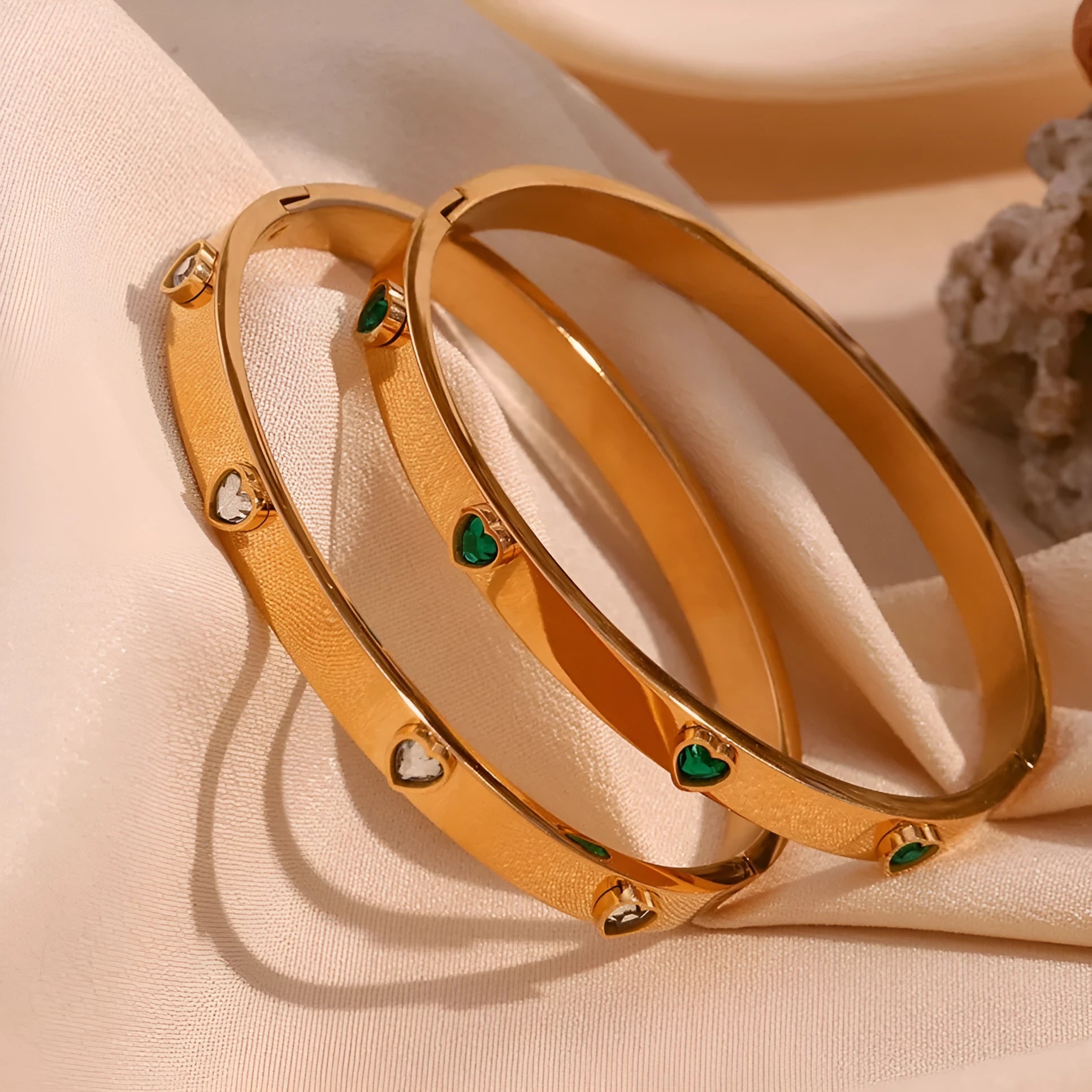 Stainless steel bracelet with a micro-inlaid peach heart charm in a golden electroplated finish.