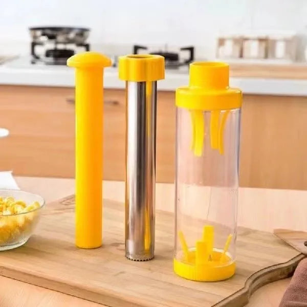 Yellow cylindrical corn stripper tool with stainless steel components on kitchen counter