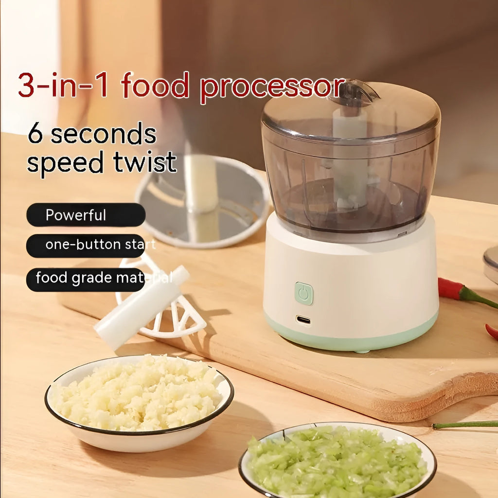 White and light green mini electric meat grinder with stainless steel blade on kitchen counter