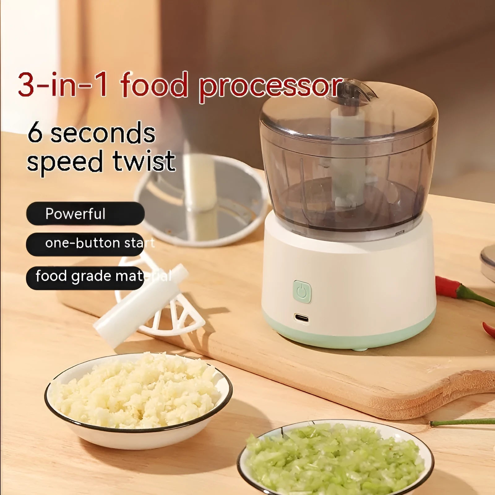 White and light green mini electric meat grinder with stainless steel blade on kitchen counter