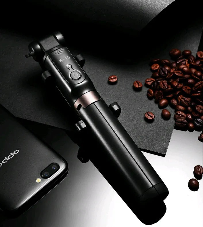 Aluminium Bluetooth selfie stick with tripod legs extended and wireless remote on a table