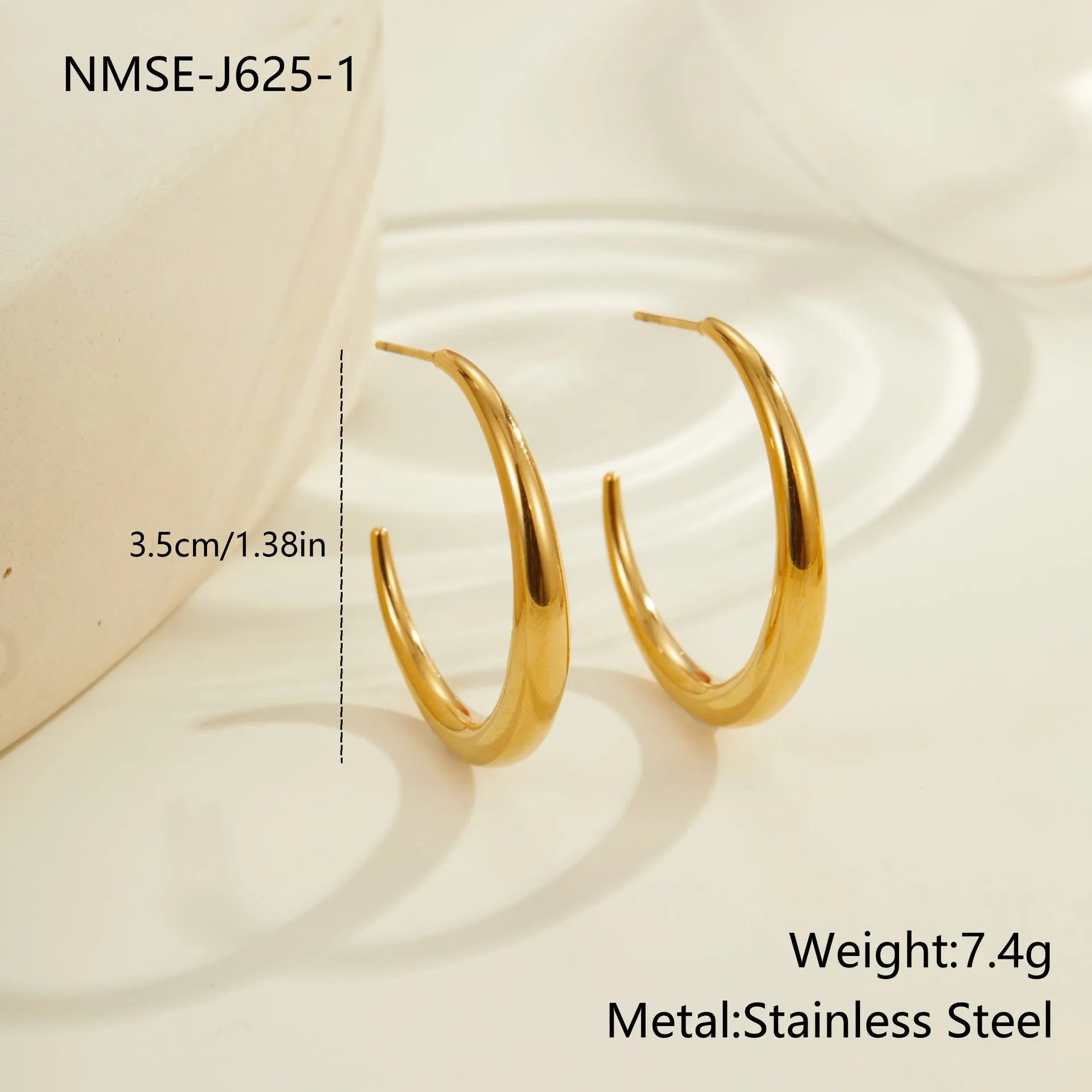 A pair of simple round titanium stainless steel hoop earrings shown in both gold and steel finishes.