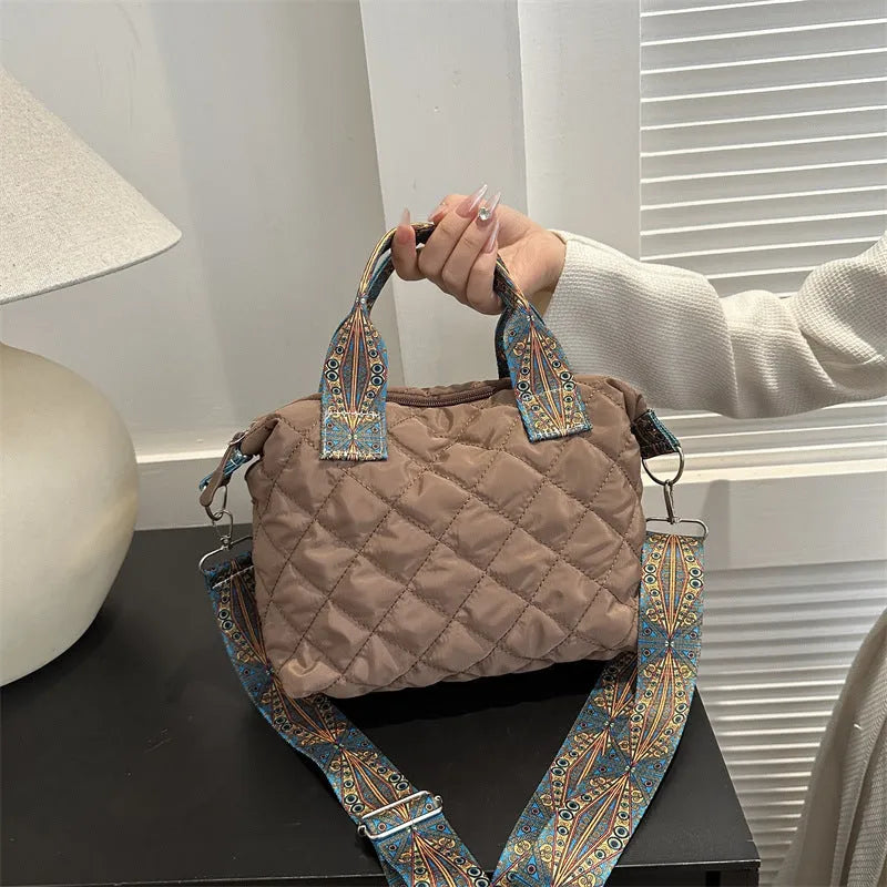 A soft Oxford cloth messenger bag in a horizontal square shape with a single shoulder strap, shown in one of five available colours.