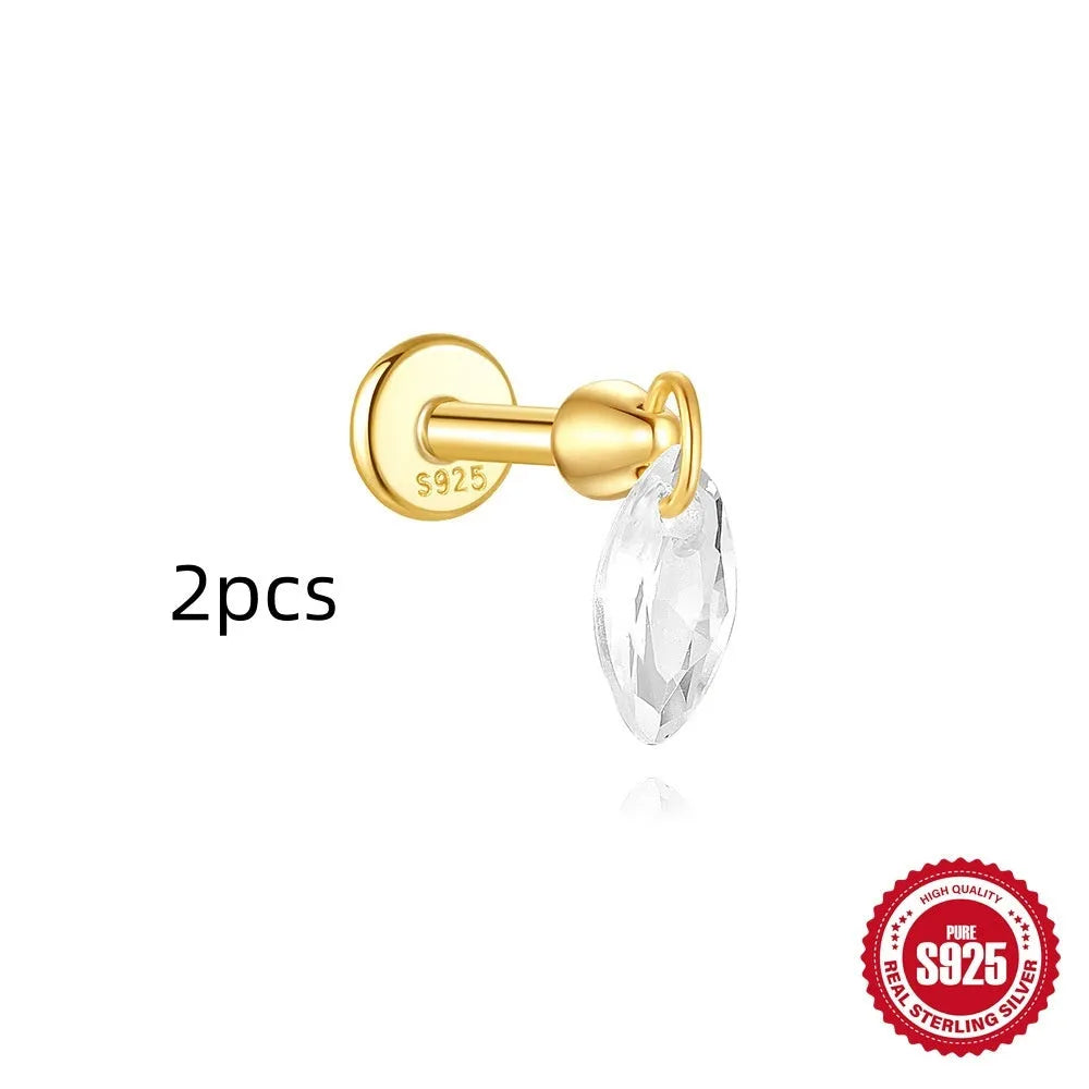 Geometric kite-shaped sterling silver stud earrings with rhinestones and a gold chain tassel.