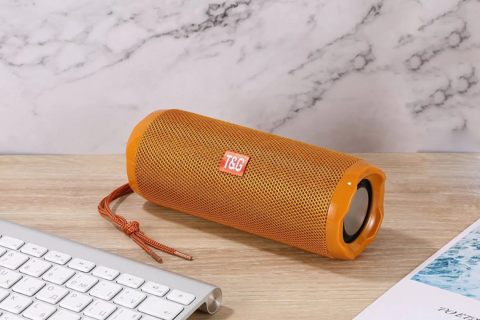 Blue portable Bluetooth speaker with a fabric card holder on the front