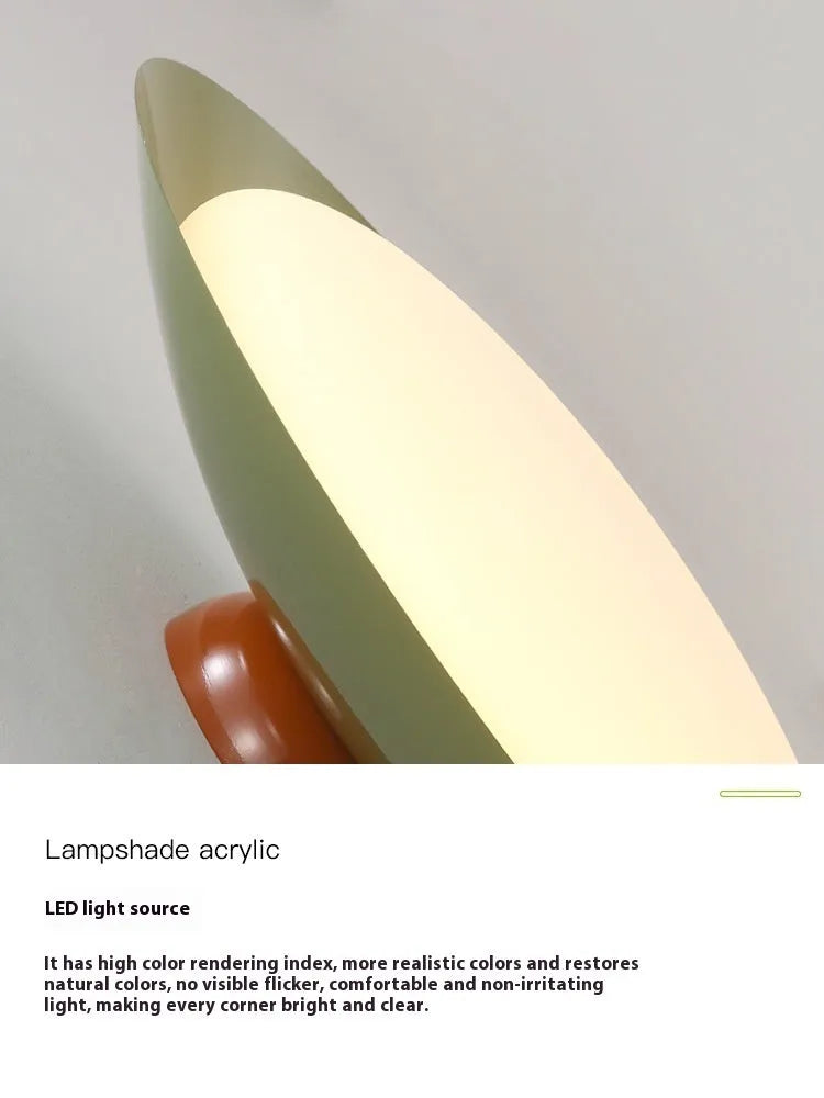 Modern minimalist cream style flying saucer ceiling lamp in mint green on a white ceiling.