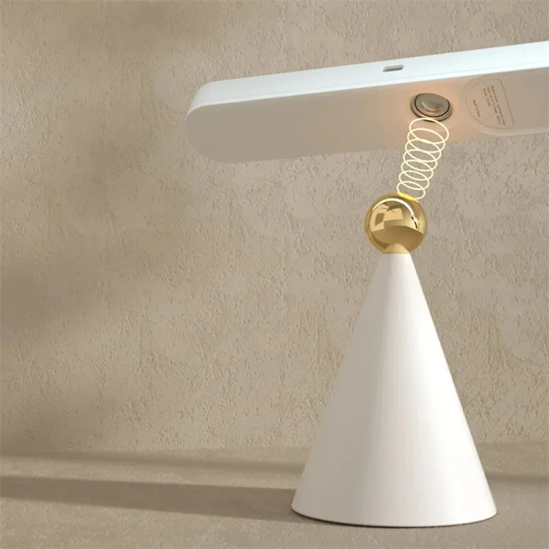 Geometric wireless table lamp with magnetic suction on metal surface showing USB connection