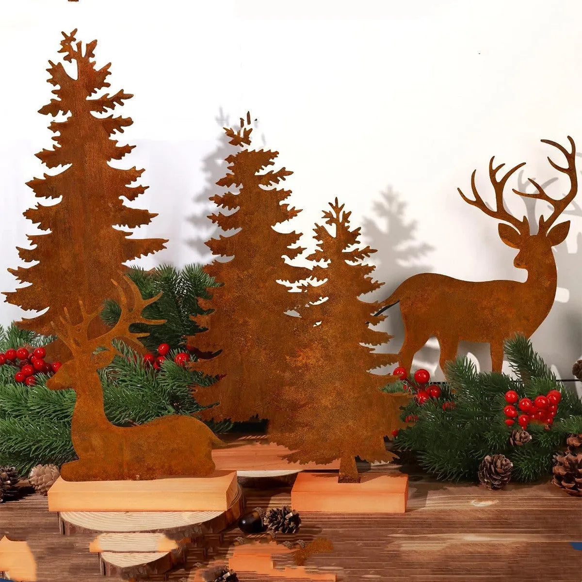 Three rusty iron Christmas decorations with elk and tree designs for rustic seasonal display