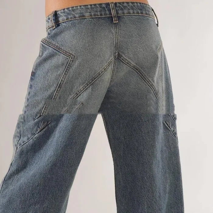 Blue cotton loose straight wide leg women's trousers on a hanger, showing low waist and stitching detail.