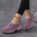Women's beige Flyknit casual sports sandals with round toe holder, shown on a foot.