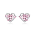 A pair of small white gold coloured heart shaped stud earrings for women on a jewellery card.