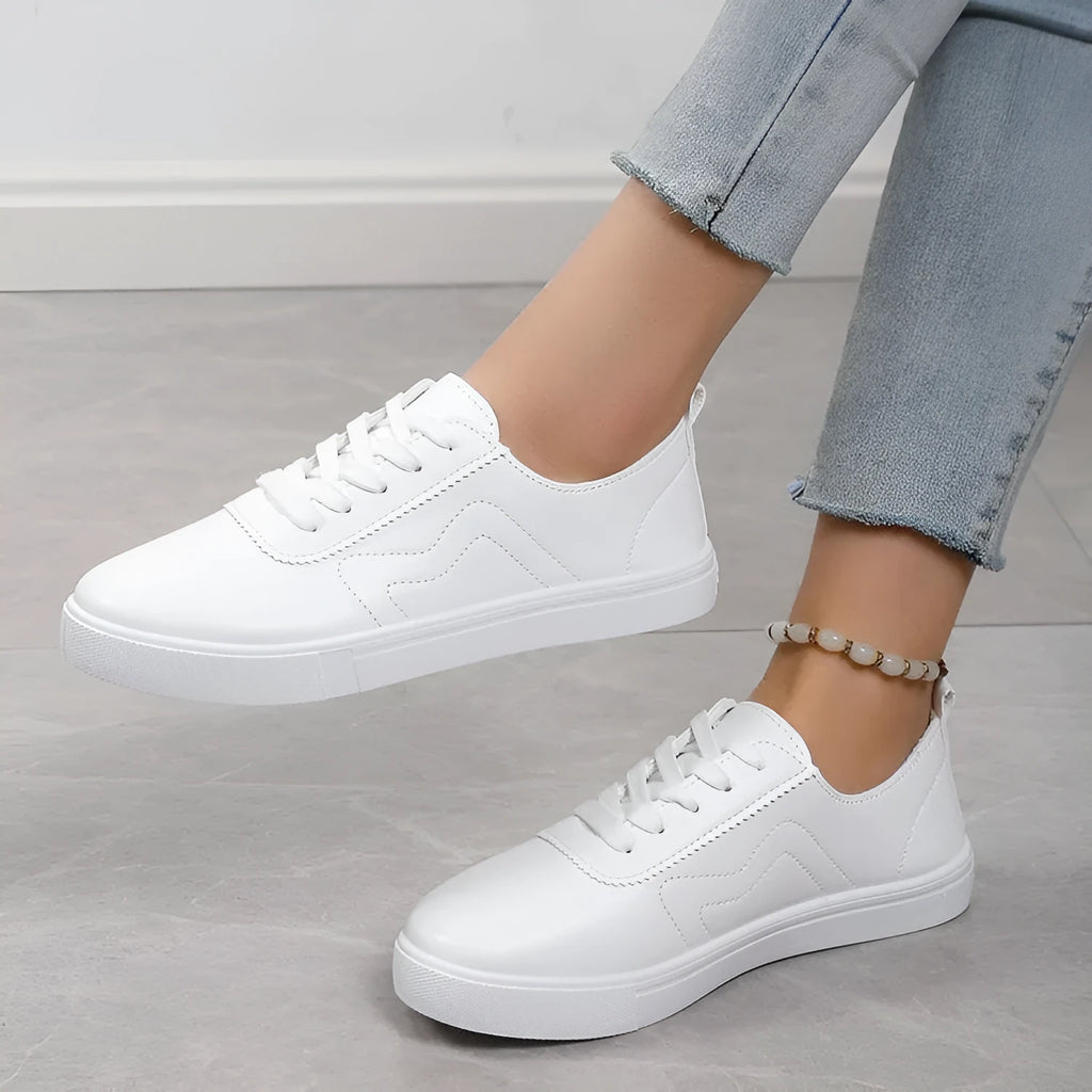 White round toe lace up casual shoes with platform heel on a flat surface