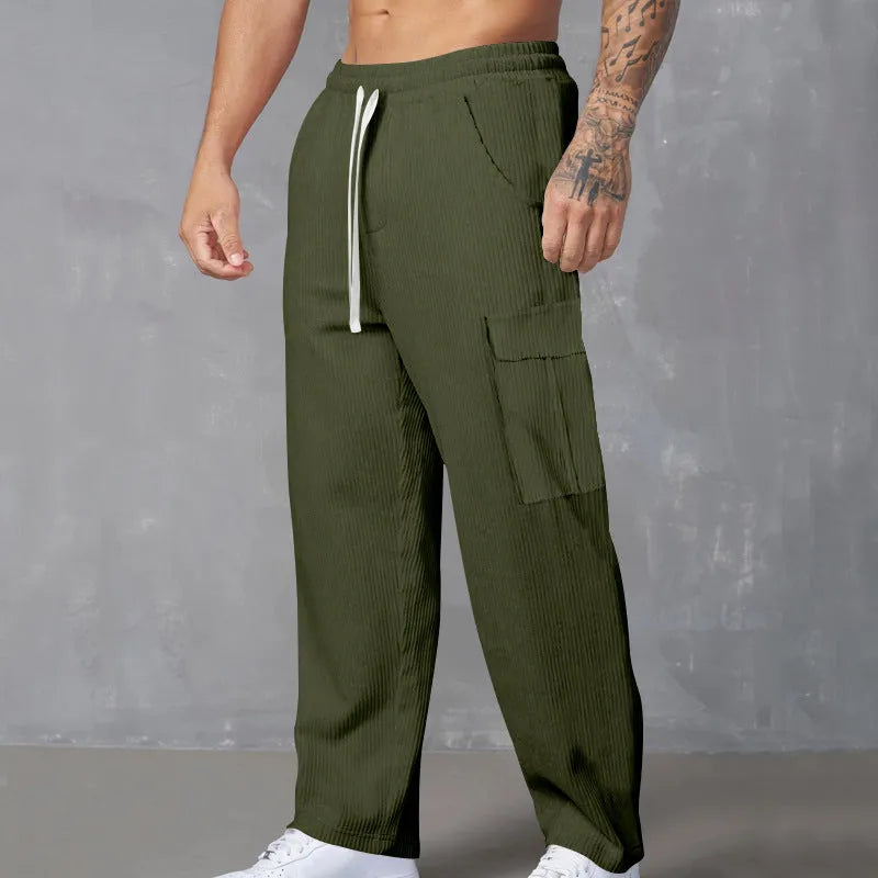 Men's corduroy cargo trousers in loose fit wide-leg design with elastic waist
