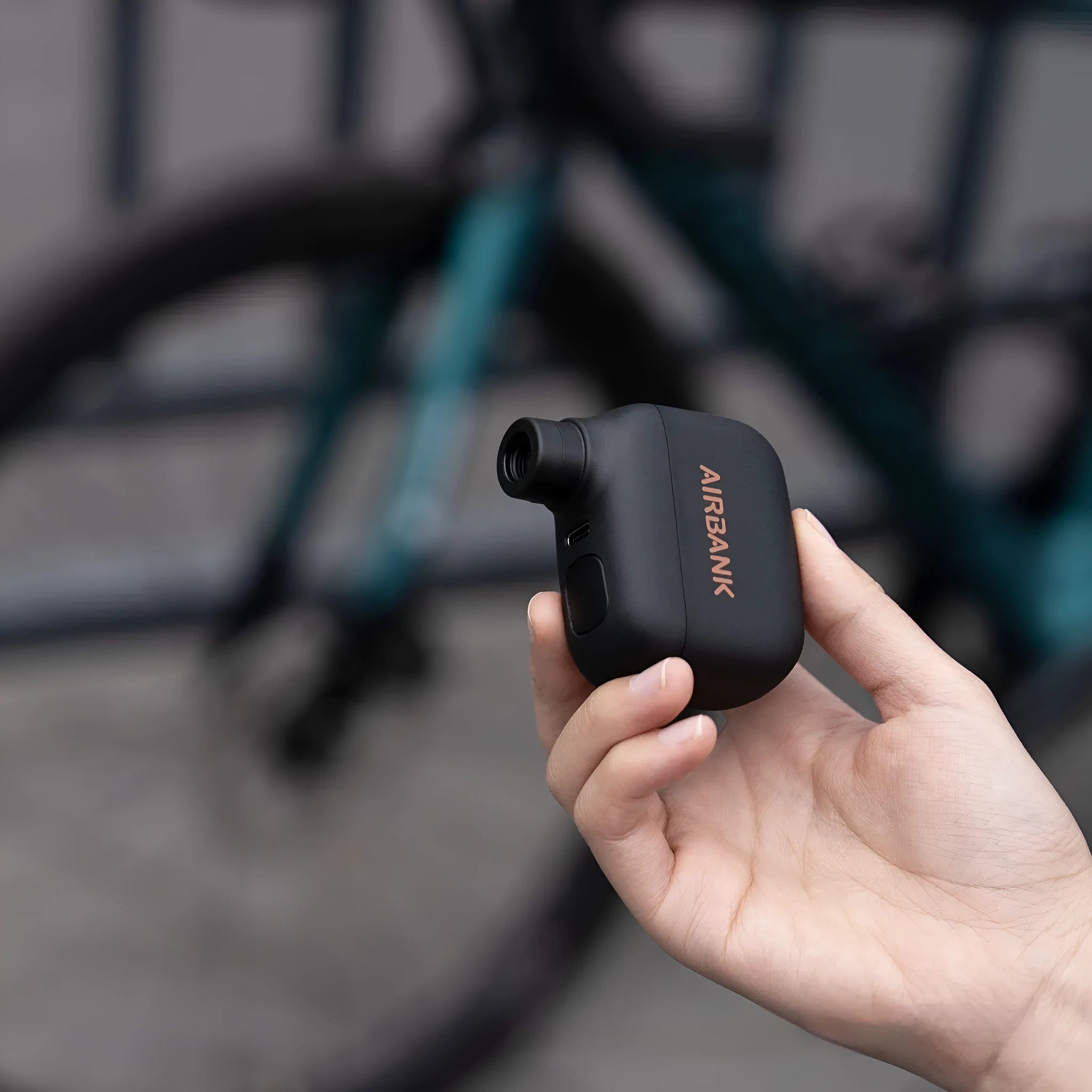 Black AS100 electric bicycle pump with USB charging cable and waterproof storage bag