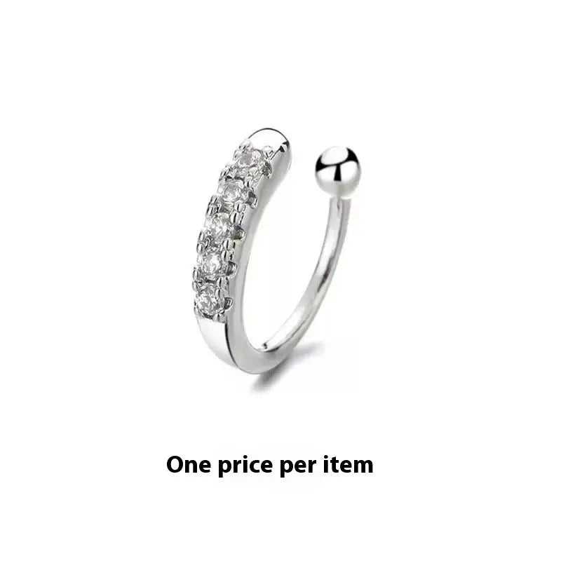 Earless nose ring with 14K electroplated copper geometric shape in silver and gold on plain background