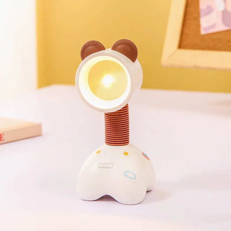 DIY cartoon animal small night lamp with magnetic base in assorted colours on a desk.