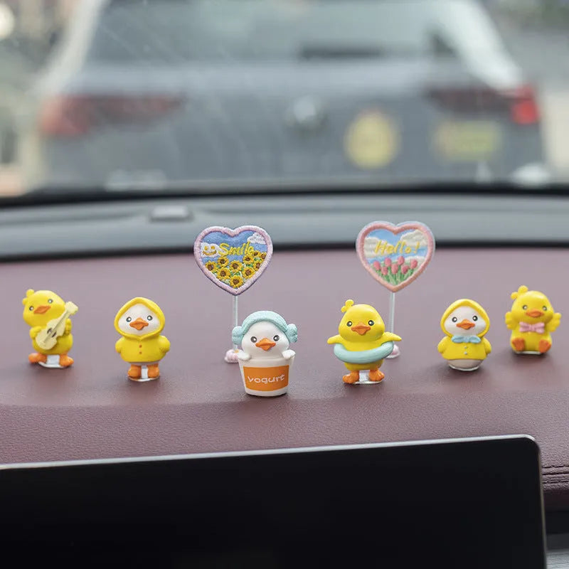 Set of six small PVC duckling ornaments and one larger Hello welcome sign for car interior decoration.
