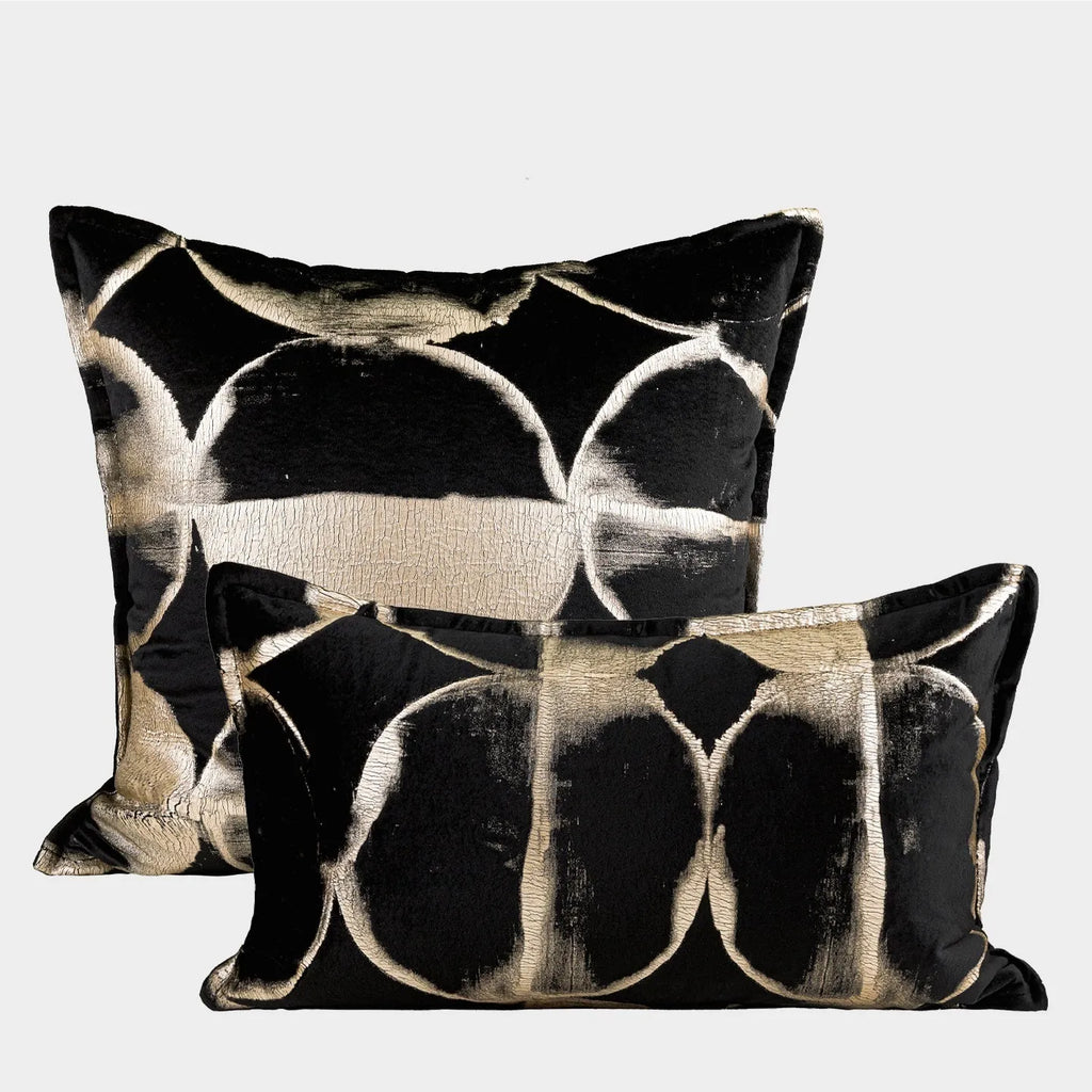 Black gold abstract pattern flannel cushion pillow in square and rectangular sizes on a sofa.