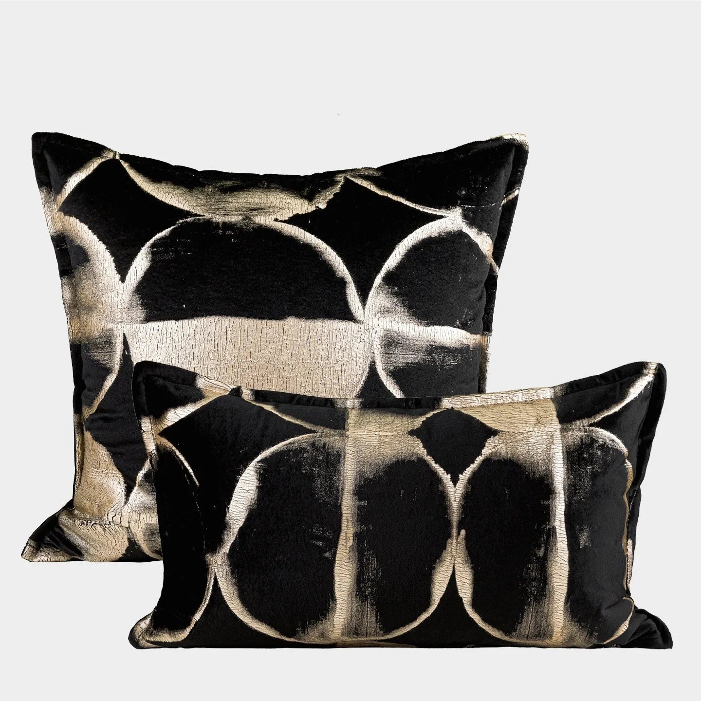 Black gold abstract pattern flannel cushion pillow in square and rectangular sizes on a sofa.