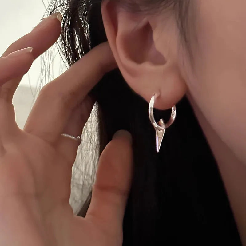 Gold electroplated copper star-shaped ear clips for women, showing geometric design.