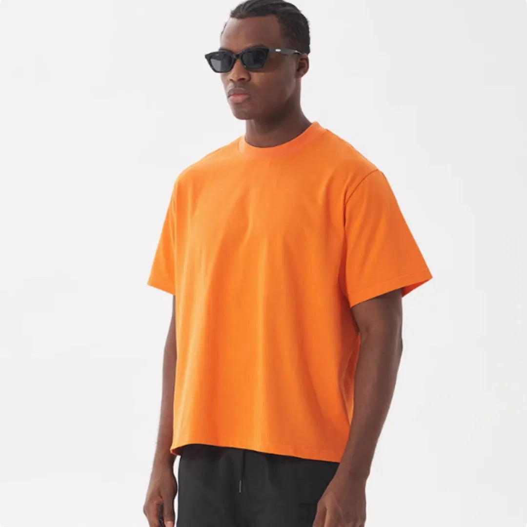 Man wearing a loose-fit apricot coloured pure cotton t-shirt, American style, short sleeves.