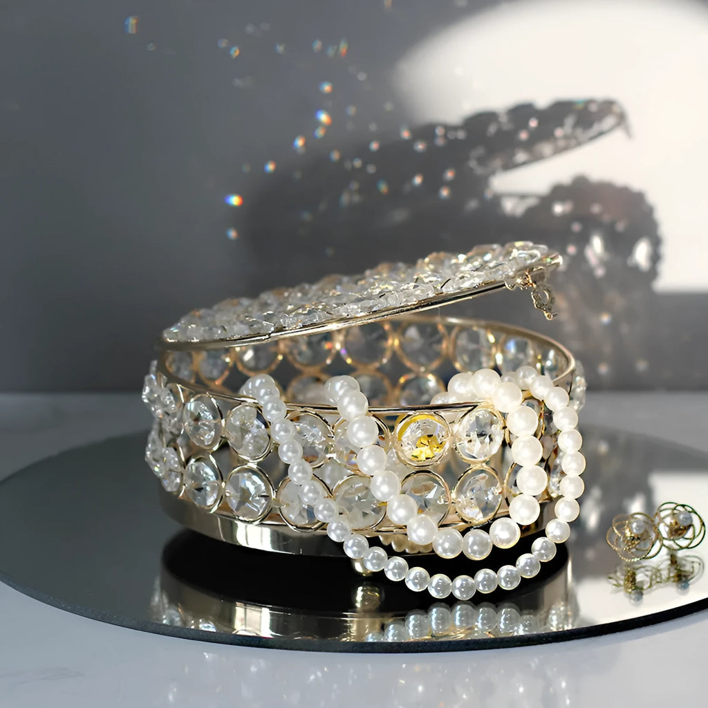 French gold iron frame crystal glass jewellery box with a metal lock closed.