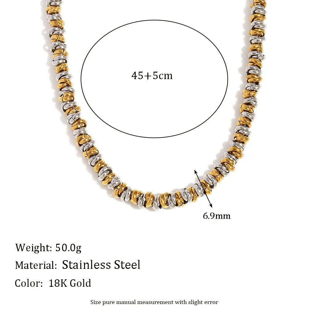 Gold geometric stainless steel earrings, bracelet, and necklace set on a white background.