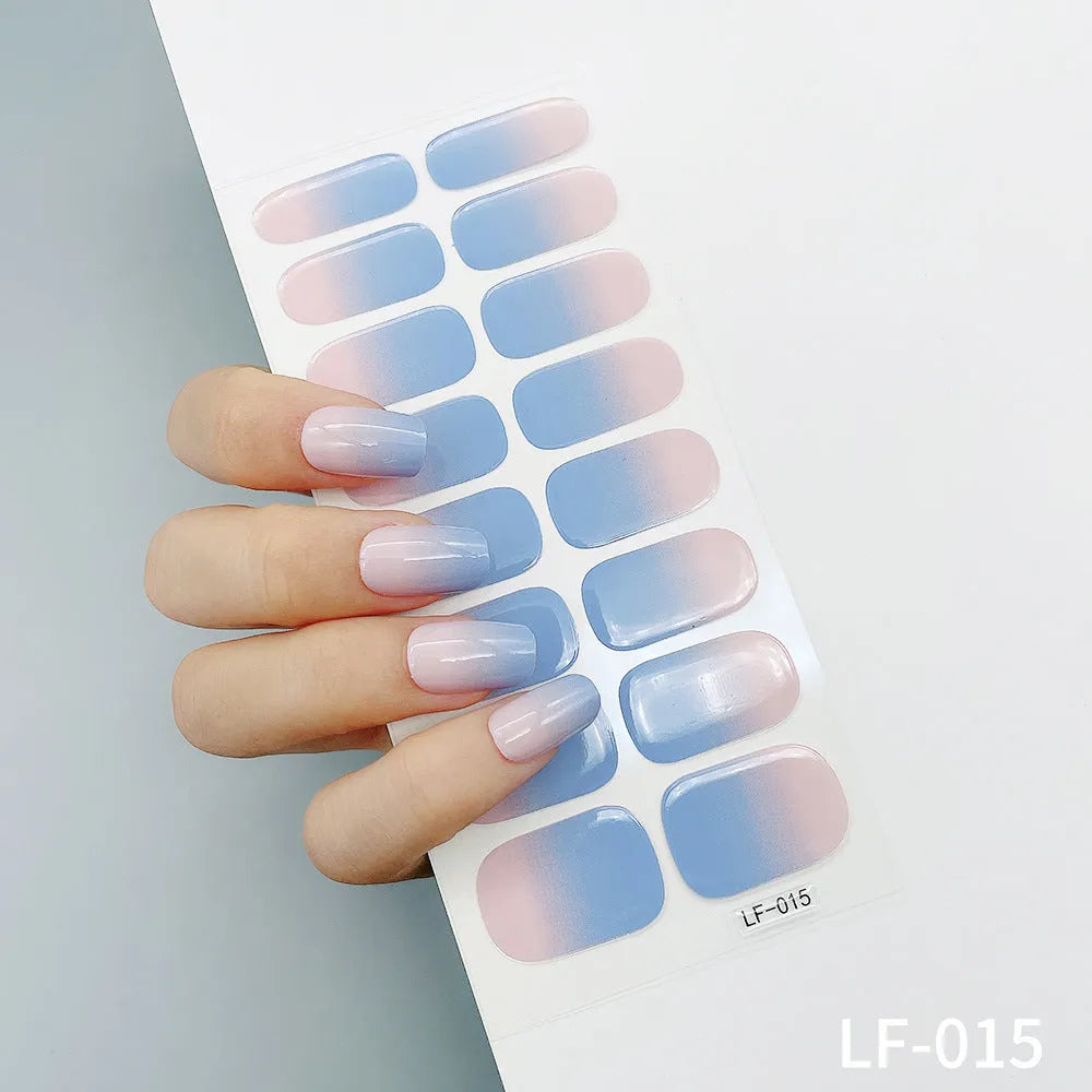 Full sheet of nail art stickers showing sixteen small designs including cross, rose, tulip, and leopard print patterns.