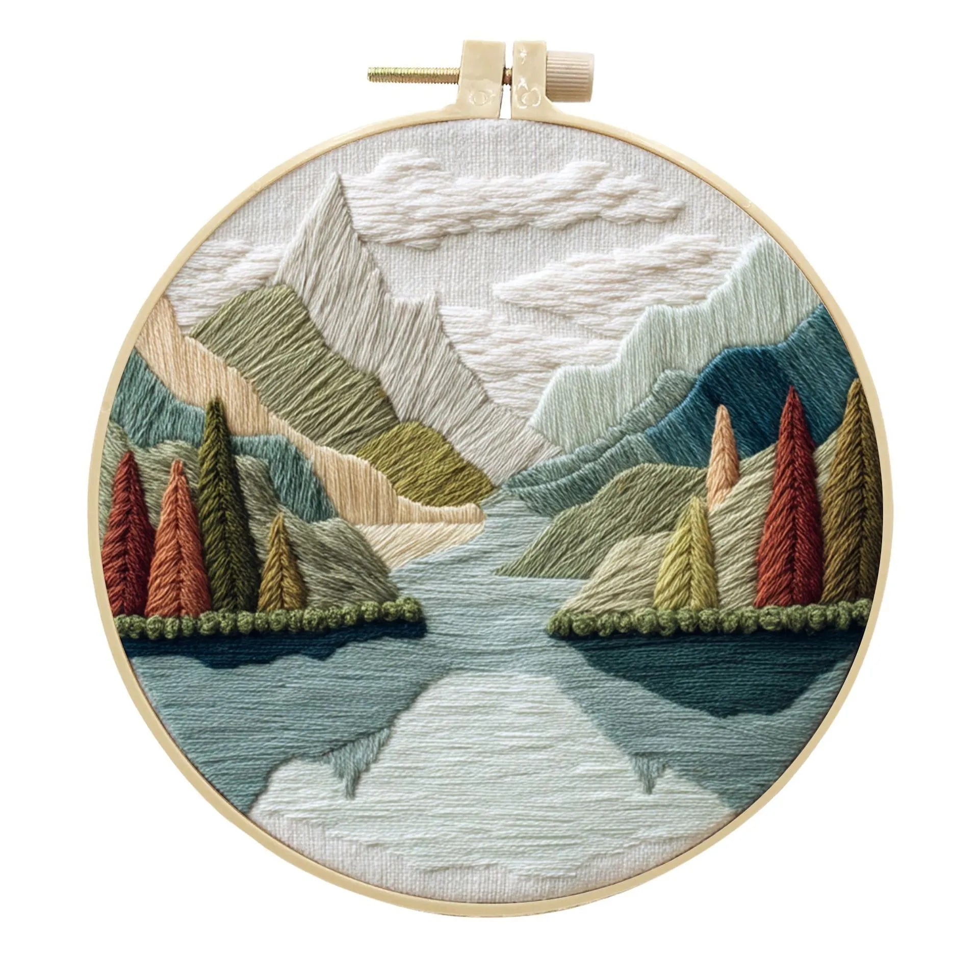 Embroidery DIY kit with bamboo frame, cotton fabric printed with a landscape scene, threads, and needles laid out