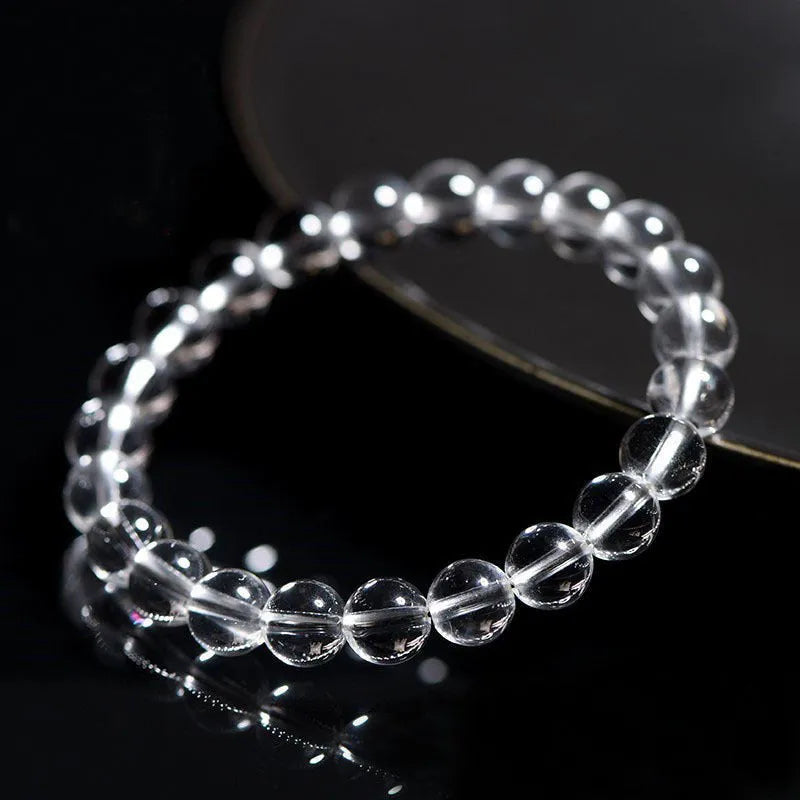 Natural Donghai old materials white water round bead crystal bracelet on a wrist, showing geometric design.